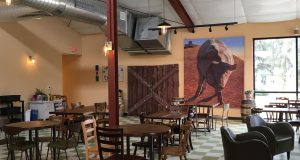 Brix Cider interior dining area with artwork of giant hog muralby S.V. Medaris