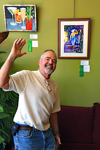 Chuck Bauer poses in front of his painting