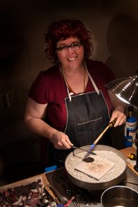 Artist, Julie Raasch at work in her studio