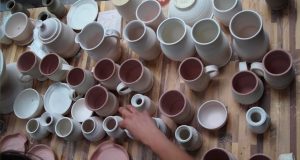 Heidi Clayton glazing mugs